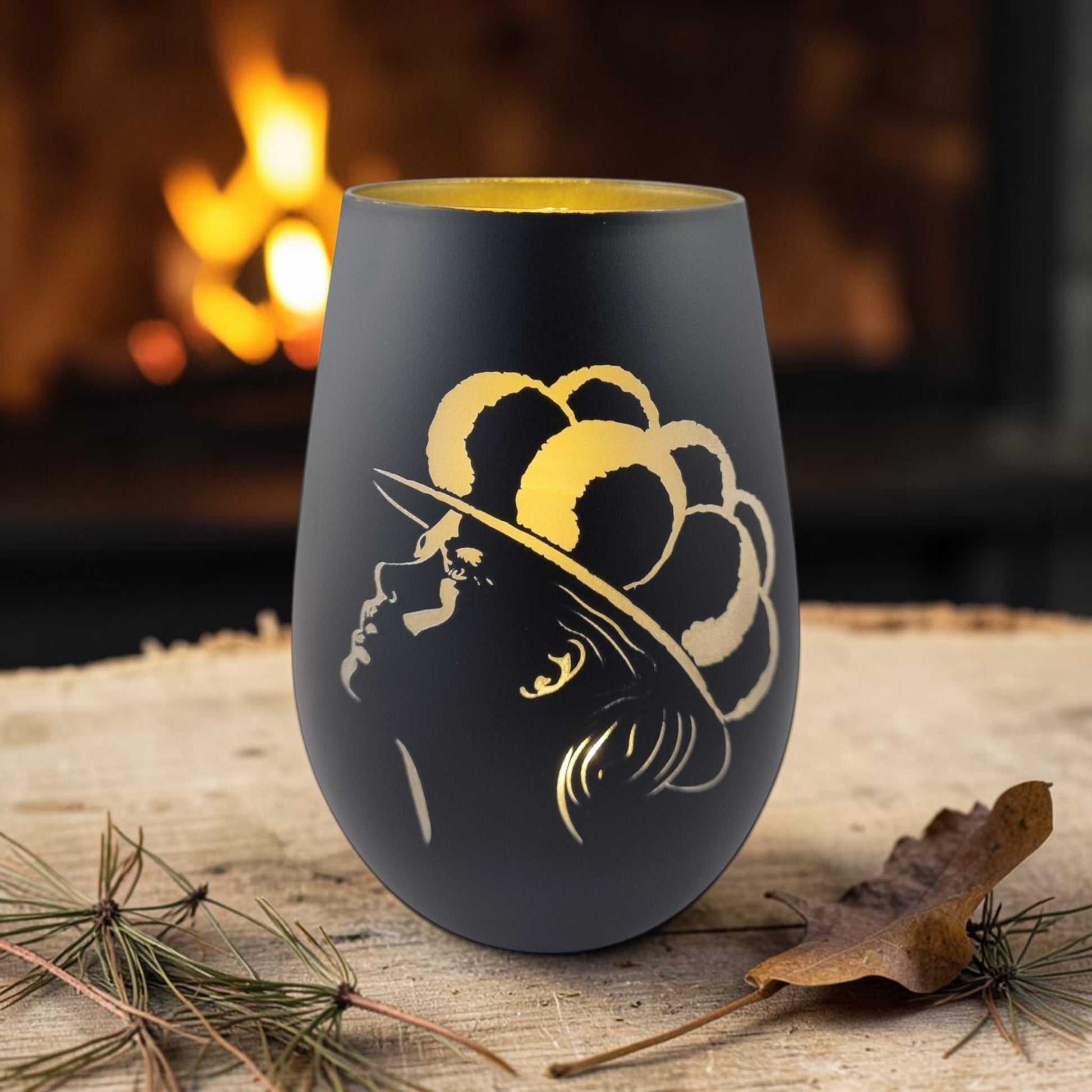 Schwarzwald Gravur black glass windlight with gold engraving of a woman's profile wearing a hat.