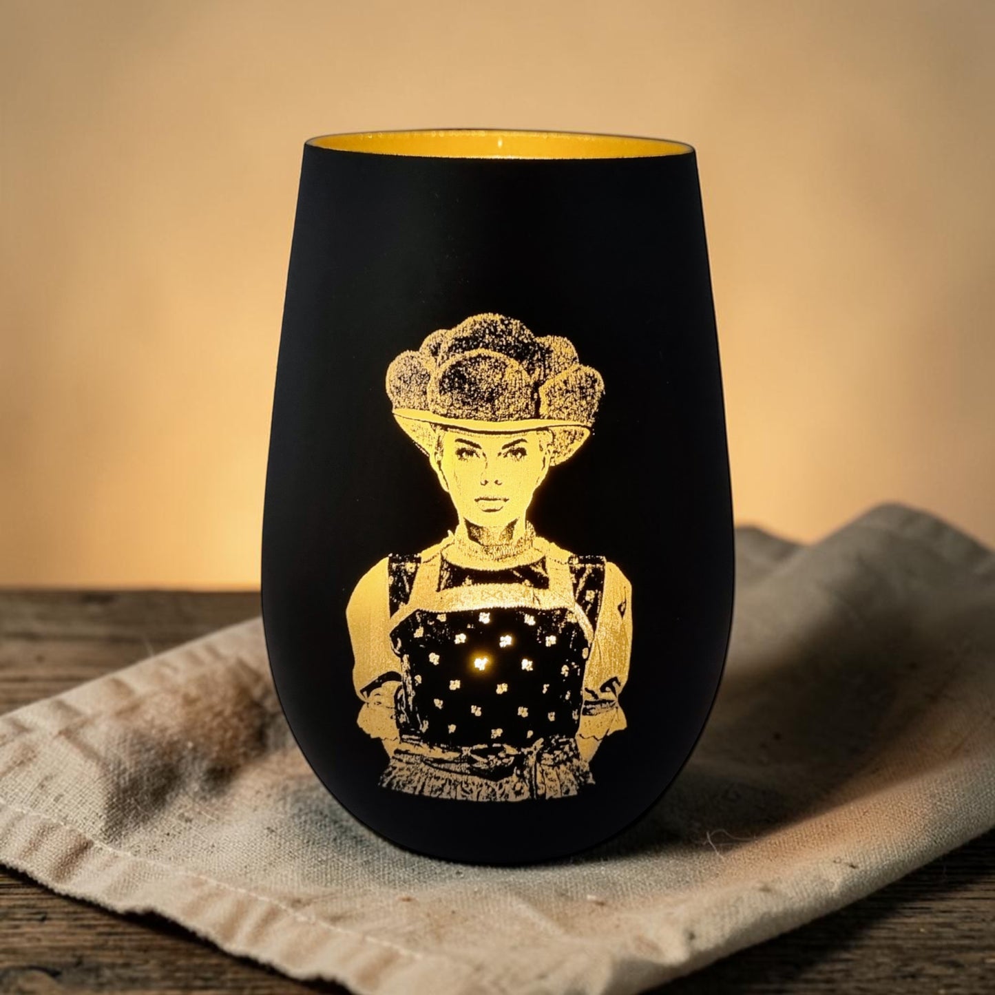 Schwarzwald Gravur black glass lantern with gold laser engraving of a girl in traditional Trachten dress and Bollenhut hat.